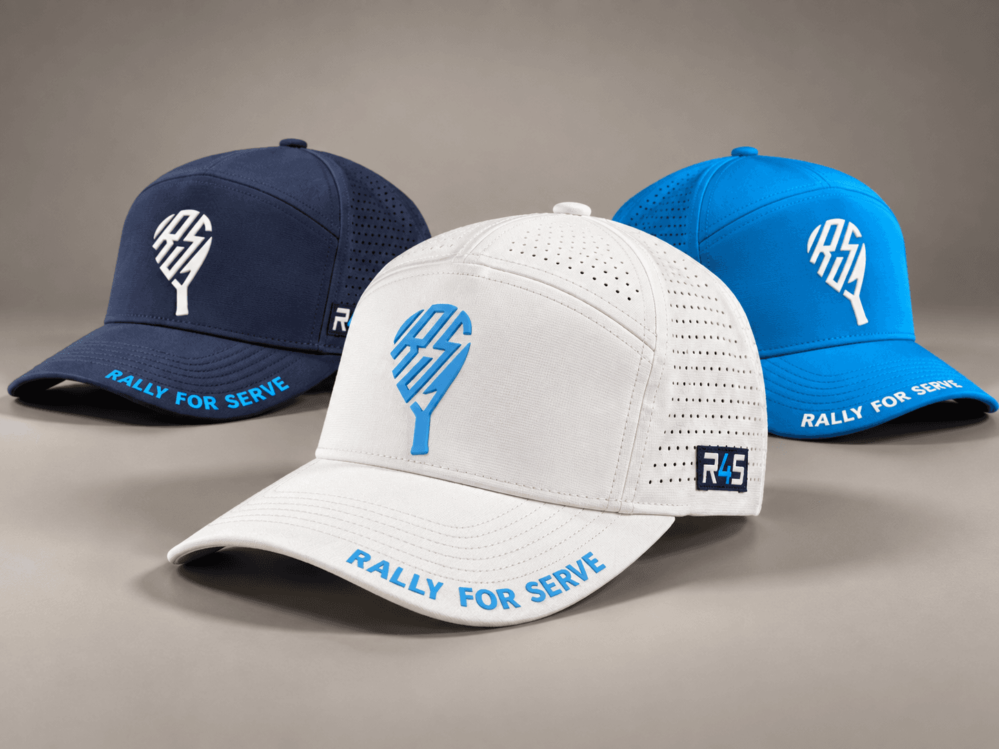 Rally Pro Court Hats in navy, white, and Rally blue showing front logos, ventilation, side patches, and brim branding