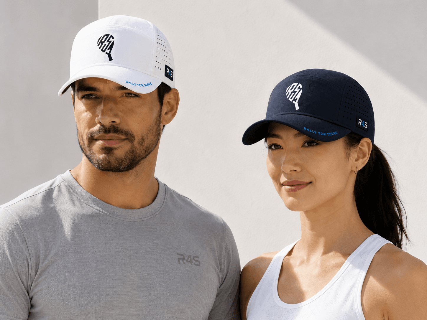 Man and woman wearing white and navy Rally Pro Court Hat development samples